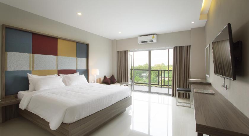 a hotel room with two beds and a television, V Hotel Ubon Ratchathani in Ubon Ratchathani