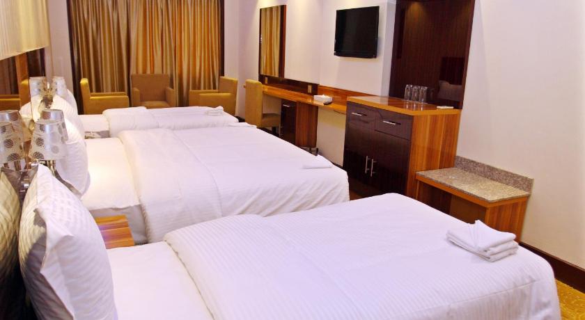 a hotel room with two beds and a television, Fal Hotel L.L.C                                                                              in Dubai