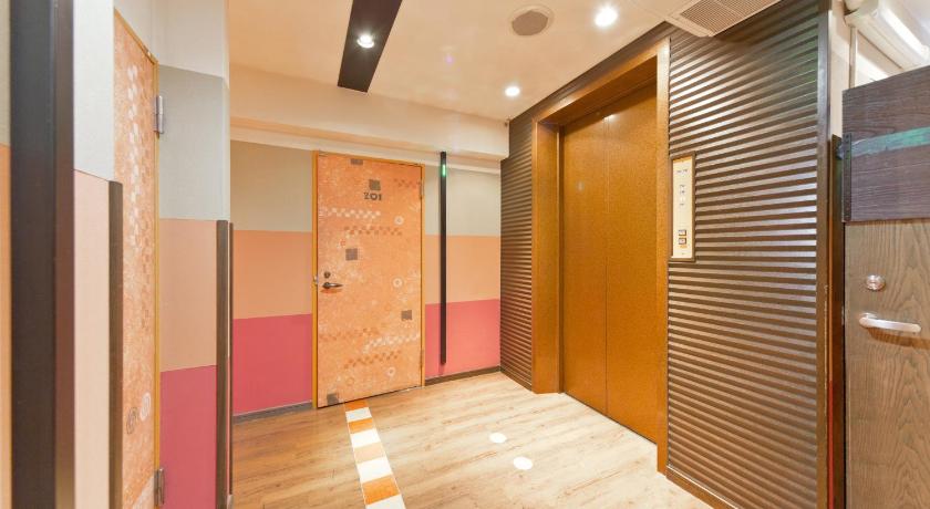 a bathroom with a door open and a large mirror, International Hotel Kabukicho in Tokyo