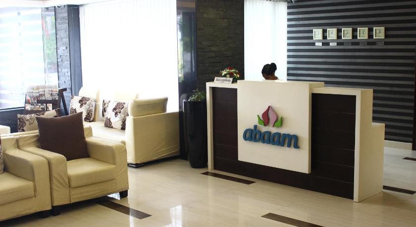 a living room filled with furniture and a tv, Abaam Hotel in Kochi
