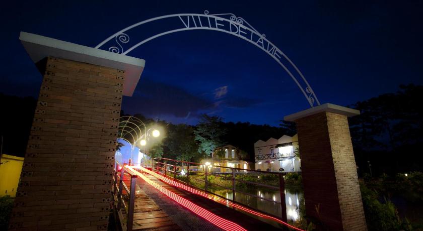 a train crossing a bridge at night, Ville De La Vie Resort in Khao Yai