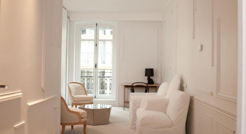 a living room filled with furniture and a window, La Maison Champs Elysees in Paris