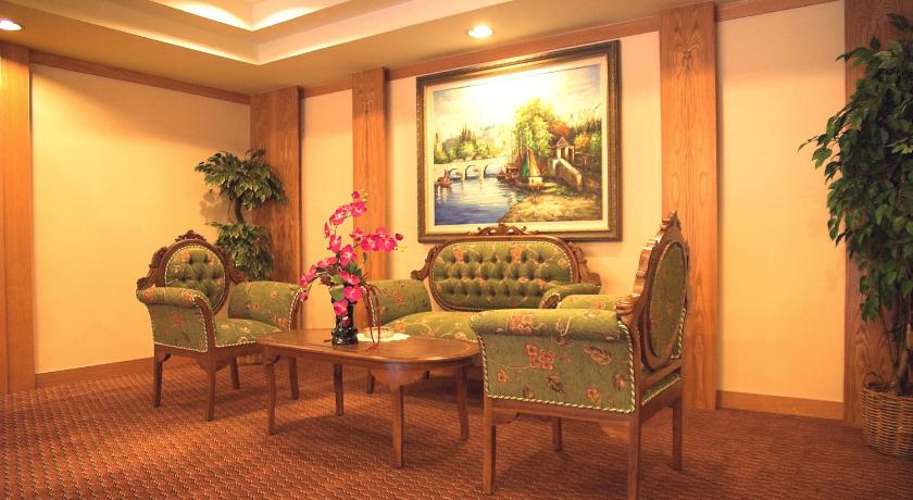 a living room filled with furniture and decorations, Hotel Regal Malaysia in Penang