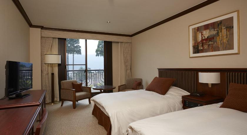 a hotel room with two beds and a television, Odakyu Hotel de Yama Hakone Lake Side in Hakone