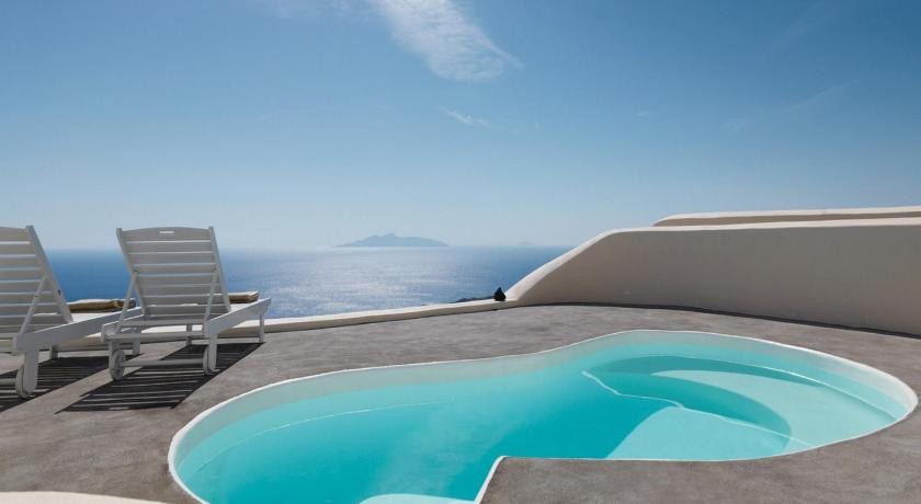 a view from a balcony of a beach with a view of the ocean, Dome Santorini Resort in Santorini