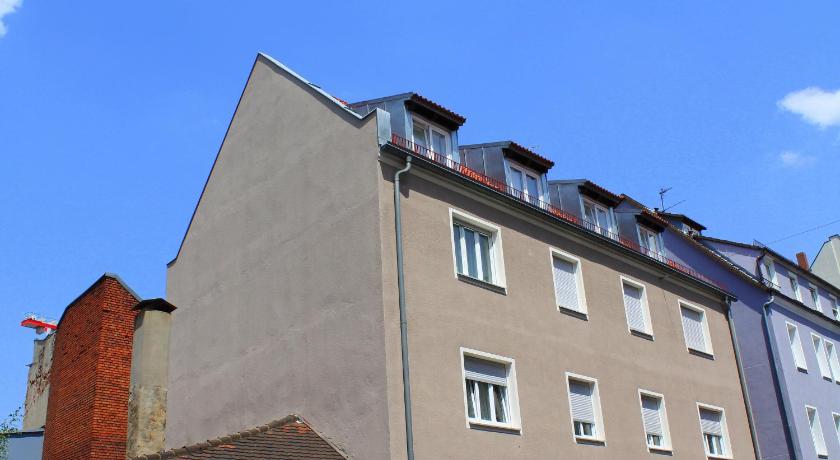 a large building with a large window on top, Apartments Thommen in Nuremberg