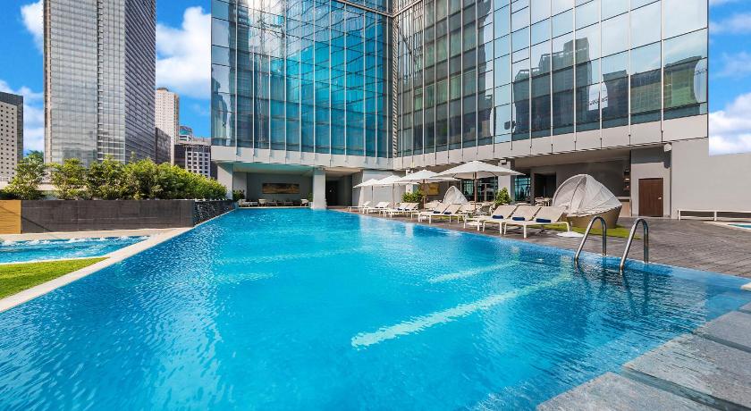 a large swimming pool in a large building, Ascott Bonifacio Global City Manila in Manila
