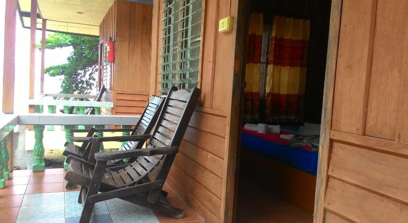 a wooden chair sitting in front of a door, Blue Lotus Resort in Ko Pha-ngan