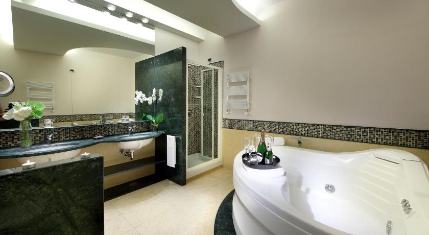 a bathroom with a large tub and a large mirror, Hotel Majestic in Naples