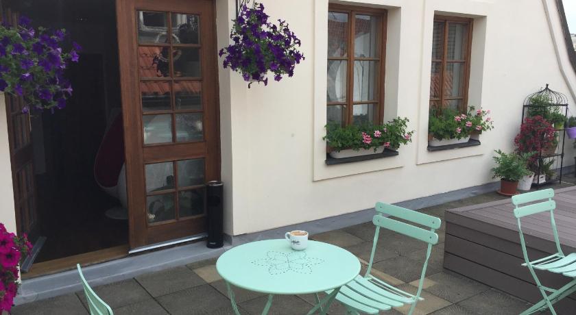 a patio area with chairs, a table, and a patio umbrella, Old Town Boutique Apartments in Prague