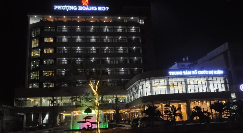 a large building with a clock on top of it, Phoenix Hotel in Thanh Hoá / Sầm Sơn Beach