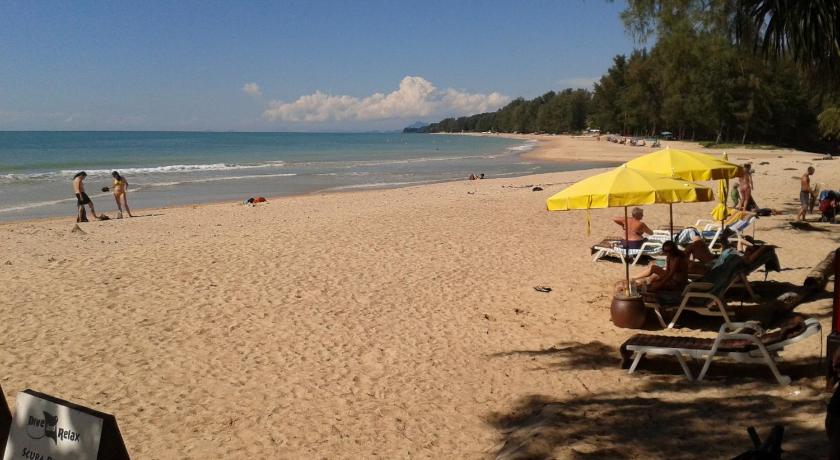 people on a beach with umbrellas, Lanta Castaway Beach Resort in Koh Lanta
