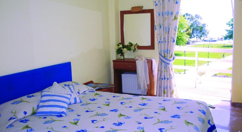 a bedroom with a bed and a window, Hotel Florakis in Livanatai
