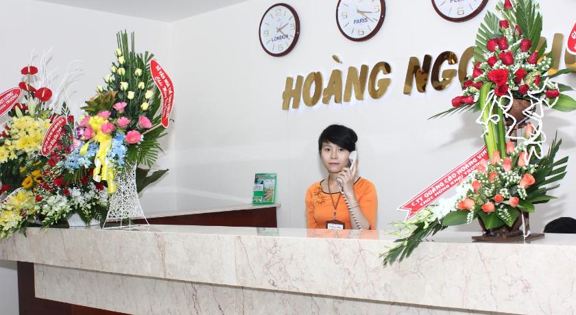 a woman standing in front of a wall with a clock on it, Hoang Ngoc Hotel in Pleiku (Gia Lai)