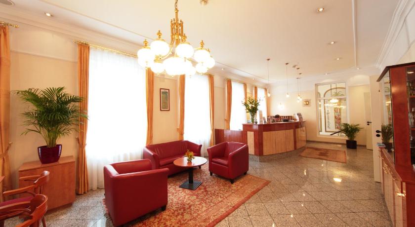 a living room filled with furniture and a red carpet, Drei Kronen Hotel Wien City in Vienna