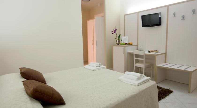a hotel room with a bed and a television, Hotel Residence Nemo in Brindisi