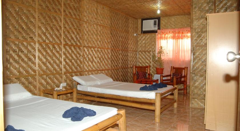a bedroom with a bed and a desk in it, Casa Keja Doljo Beach in Bohol