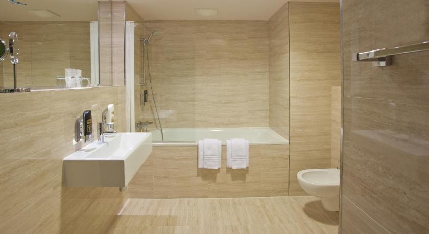 a bathroom with a sink, toilet and bathtub, Grand Majestic Hotel Prague in Prague