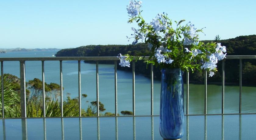 a vase filled with flowers sitting on a ledge, Pipiroa Bay Homestay in Bay of Islands
