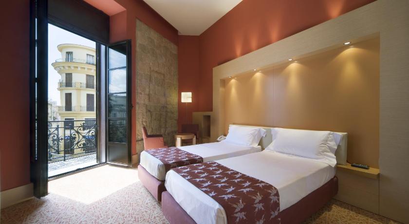 a hotel room with a large bed and a large window, UNAHOTELS Napoli in Naples