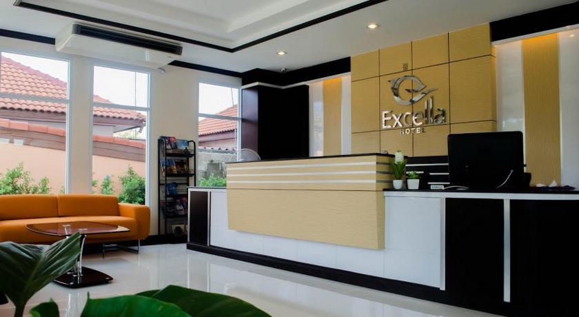 a living room filled with furniture and a large window, Excella Hotel in Ubon Ratchathani