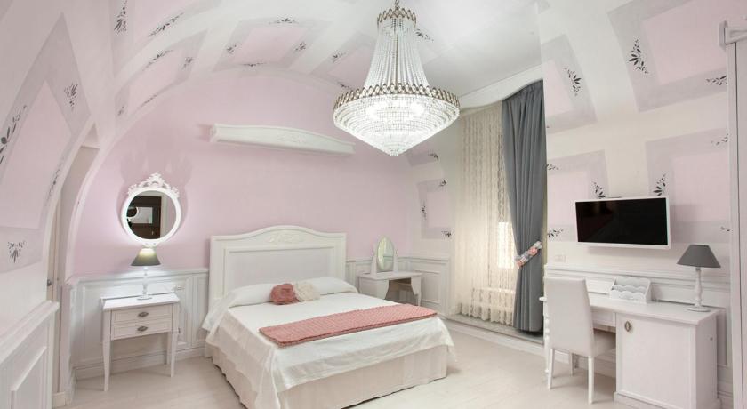 a bedroom with a bed and a television, Domus Rosa in Naples
