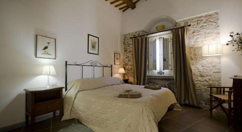 a bedroom with a bed and a dresser, Residence Erice Pietre Antiche & rooms in Trapani