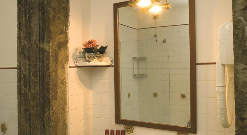 a bathroom with a sink and a mirror, Antico Palazzo Rospigliosi Hotel in Rome