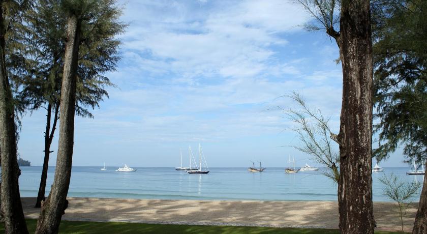 a large body of water with a sailboat in the distance, Dusit Thani Laguna Phuket Hotel (SHA Extra Plus) in Phuket