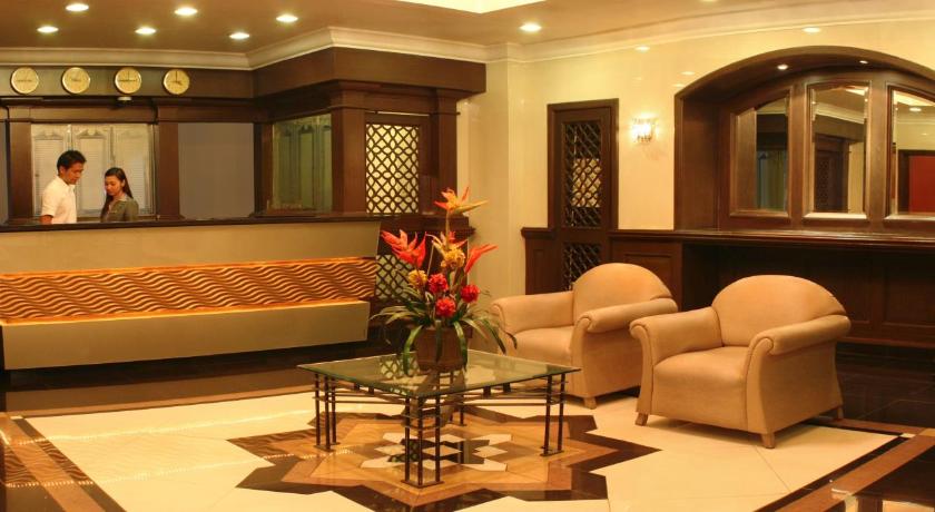 a living room filled with furniture and decor, Riviera Mansion Hotel in Manila