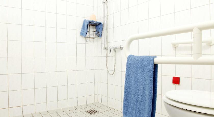a bathroom with a toilet and a shower stall, acama Hotel + Hostel Kreuzberg in Berlin
