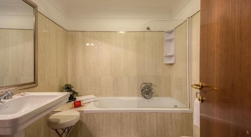 a bathroom with a sink, toilet and bathtub, Antico Palazzo Rospigliosi Hotel in Rome