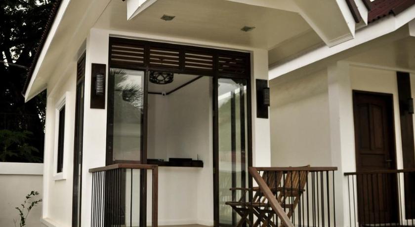 a white and black house with a white and black porch, Cleon Villas Pension in Palawan