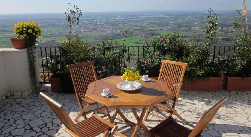 a table with chairs and a table cloth on top of it, Le Camere Pinte in Sermoneta