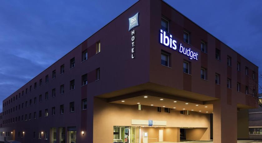 a large building with a clock on the front of it, Ibis Budget Zurich Airport in Zürich
