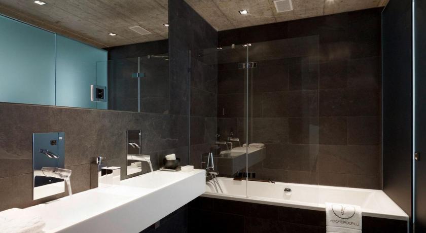 a bathroom with two sinks and a large mirror, VISIONAPARTMENTS Zurich Wolframplatz in Zürich