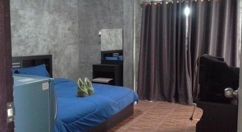 a bedroom with a bed and a television, Bansappoori in Lamphun