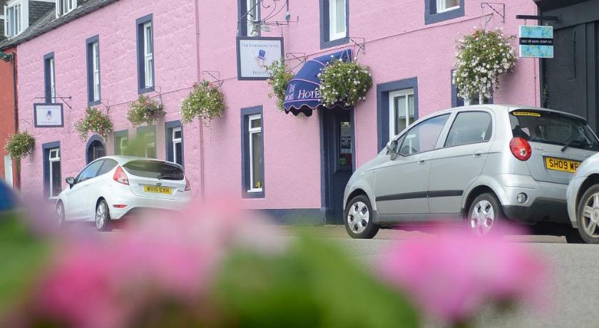 a car parked on the side of a street next to a building, The Tobermory Hotel in Tobermory