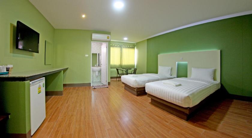a living room with two beds and a television, Central Park Hotel in Sing Buri