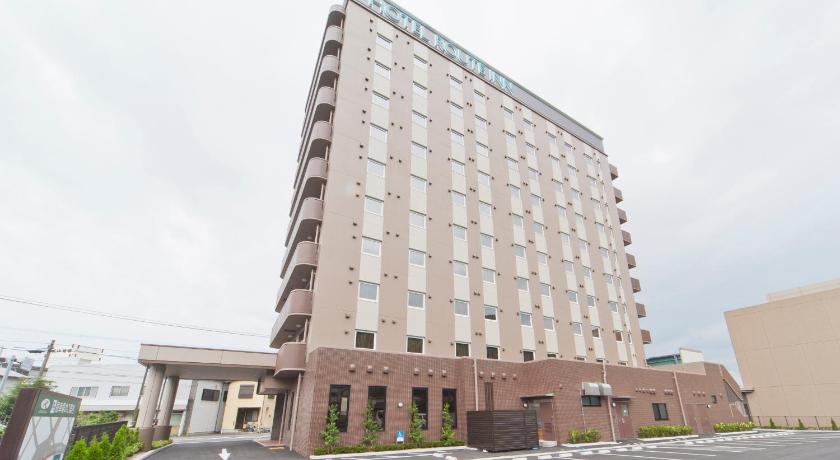 a large building with a large clock on the side of it, Hotel Route Inn Saiki Ekimae in Oita