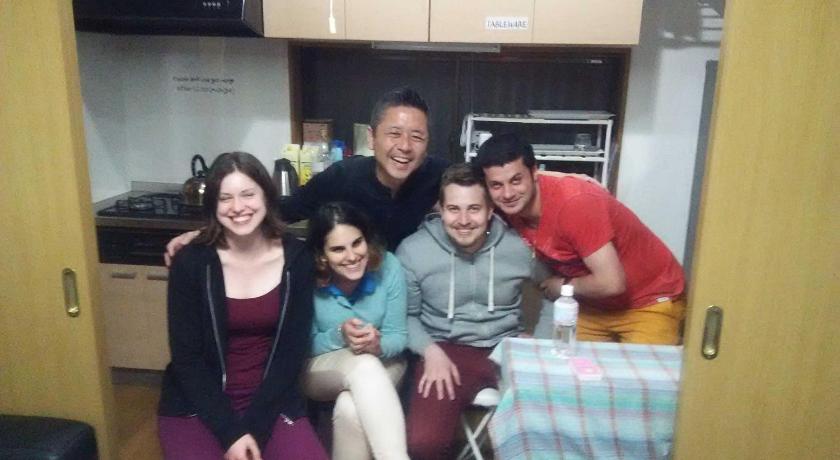 a family posing for a picture in a kitchen, J's backpackers in Tokyo