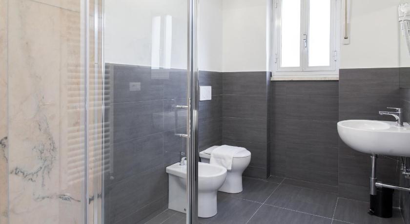 a bathroom with a toilet, sink, and shower, La Casa delle Acciughe Guest House in La Spezia