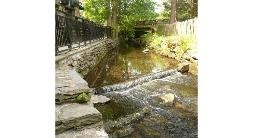a river that has a waterfall in it, The Watermill Inn & Brewery in Kendal
