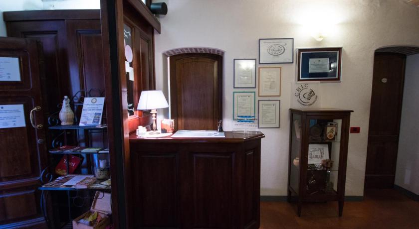 a woman standing in front of a mirror in a room, Locanda Del Feudo Charme & Relax in Castelvetro di Modena