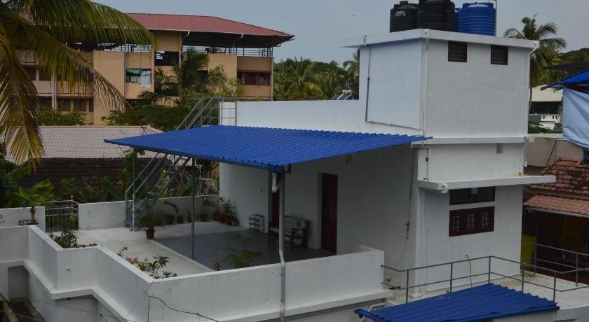 a blue and white boat sitting on top of a building, Aldos Ark Home Stay in Kochi