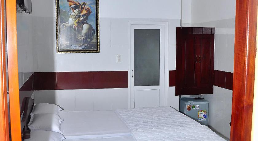 a hotel room with a bed and a mirror, Guest House 36 (2) in Rach Gia (Kien Giang)