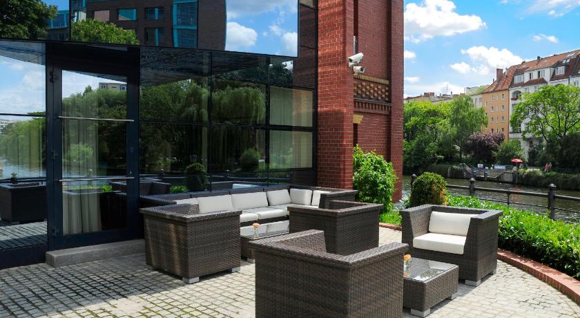 a row of wooden benches in front of a brick building, Ameron Boutique Hotel Villa Abion Berlin in Berlin
