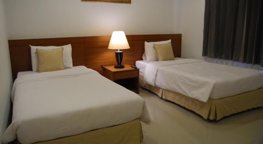 a hotel room with two beds and two lamps, Green House Phuket in Phuket