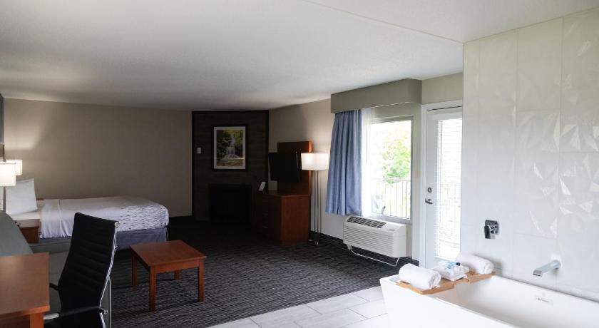 Image of King Room w/ Soaking Tub, Sofa Bed w/ fire place & private balcony 8