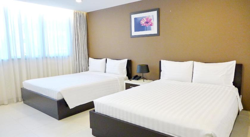 a hotel room with two beds and a television, Minh Khang Hotel in Ho Chi Minh City
